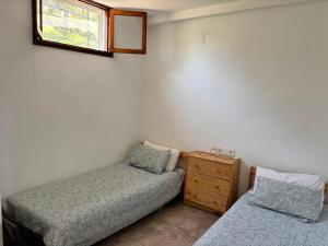 a bedroom with two beds and a window at Maison de plage Marsa M'diq 2 chambres et Salon in M'diq