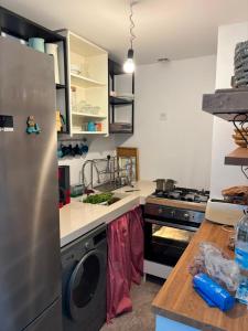a kitchen with a stainless steel refrigerator and a stove at Maison de plage Marsa M'diq 2 chambres et Salon in M'diq