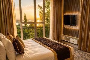 a hotel room with a bed and a large window at Vale Montis Near Dal Lake Srinagar in Srinagar +35 photos