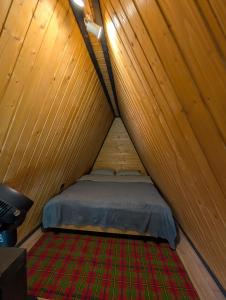 a room with a bed in a tent at Hanul Haiducilor in Şendreni +11 photos