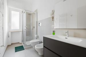 a bathroom with a sink and a toilet and a shower at Scirocco Guest House in Brindisi
