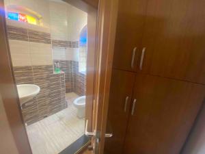 a bathroom with a toilet and a sink at Kosvegas Apartment in Kosovo Polje