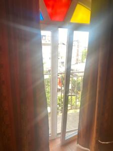 a room with a window with a rainbow at Kosvegas Apartment in Kosovo Polje