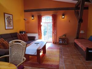 a living room with a couch and a table at Ferien am Schloss - Wohnung 4 "der Hund", Ferienwohnung am Badesee in Behren-Lübchin +30 photos