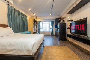 a hotel room with a bed and a television at Sam's Apartment in Pātan