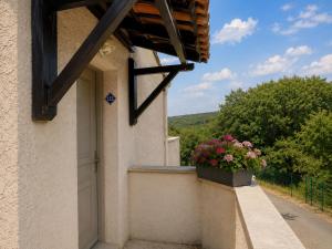 a building with a flower pot on a balcony at La TERRASSE in Salavas +2 photos