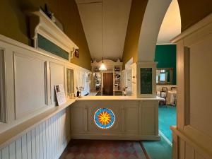 a hallway with a stained glass window in a house at Laitse Castle B&B in Laitse