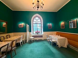 a dining room with tables and a window at Laitse Castle B&B in Laitse