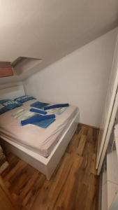 a bed in a small room with a wooden floor at Eos in Piran