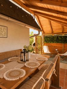 a wooden table in a living room with a wooden roof at Guesthouse Mreznica- Mreznicka Idila resort in Galović-Selo