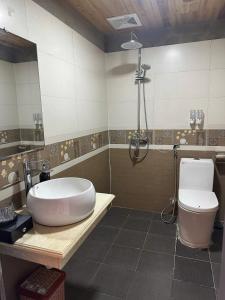 a bathroom with a sink and a shower and a toilet at TaVan Eco Home in Tả Van