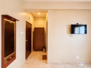 a hallway with a television on a wall at Hotel Puri Waves - Near Blue Flag Beach - Restautant, Parking & Spa in Puri