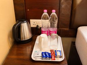 two bottles of water on a tray on a table at Hotel Puri Waves - Near Blue Flag Beach - Restautant, Parking & Spa in Puri +9 photos
