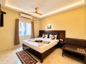 a bedroom with a large bed and a couch at Hotel Puri Waves - Near Blue Flag Beach - Restautant, Parking & Spa in Puri