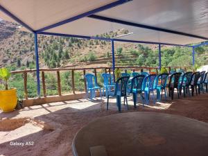 a group of blue chairs sitting under a tent at Auberge amazrane in Matat +16 photos