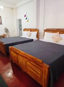 two beds in a room with two beds sidx sidx sidx at The Green Heritance in Habarana