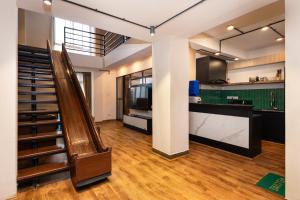 a staircase in a room with a kitchen and a counter at Sam's Apartment in Pātan +57 photos
