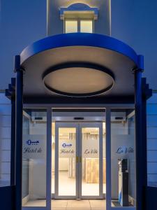 a store front with two glass doors in front at Hotel de La Ville - Self Check-In in Fidenza