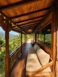 a bed on a porch with a view at Zen Tree House in Silebeng