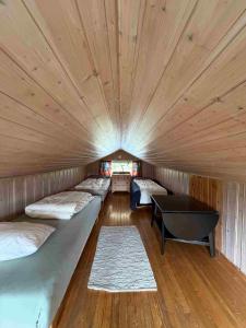 a room with four beds and a table in it at Arctic Motel and Kautokeino Camping in Kautokeino
