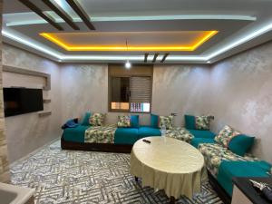 a living room with a couch and a table at Tamri beach house in Agadir