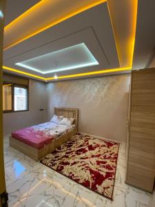 a bedroom with a bed and a rug on the floor at Tamri beach house in Agadir