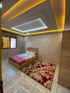 a bedroom with a bed and a rug on the floor at Tamri beach house in Agadir