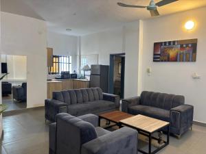 a living room with couches and a table at Chez Gero Aeroport in Cotonou