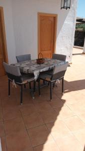 a table with two chairs and a basket on top of it at Casa Benzambra in Cádiar +30 photos
