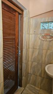 a bathroom with a shower with a toilet and a sink at Recanto do major in Petrópolis +18 photos