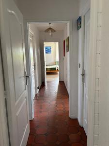 an empty hallway with a tile floor and an open door at Chambres d hôtes vue mer au gré des marées Plouguerneau Bretagne in Plouguerneau +18 photos