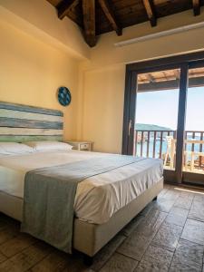 a bedroom with a large bed and a large window at Hotel Costa Paradiso in Costa Paradiso +69 photos
