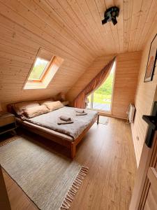 a bedroom with a bed in a wooden cabin at Mielno Woodhouse in Mielno
