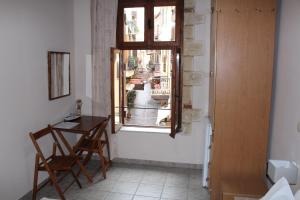 a room with a table and a window at My Rooms in Chania Town