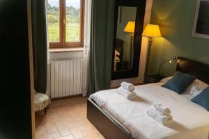 a bedroom with a bed with towels on it at My Tuscany Suites in Castiglioncello +39 photos