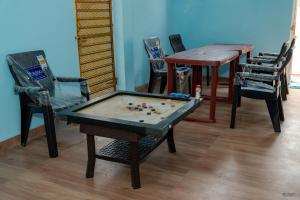 a room with a table and chairs with a pool table at Ananda Villa in Igatpuri