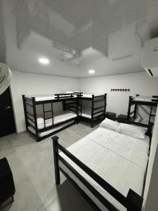 a room with three bunk beds in it at Hotel Logistico in Santa Marta