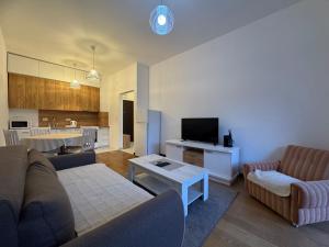 a living room with a couch and a table at Przno in Pržno