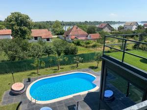 a swimming pool on the balcony of a house at Ailleurs in Novi Banovci