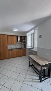 a large room with a table and a kitchen at case vacanza hoya in Lacco Ameno