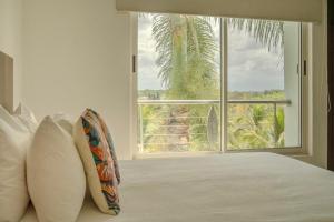 a bedroom with a bed with a large window at Nitta 301 Escápate a Nuevo Vallarta in Nuevo Nayarit +28 photos