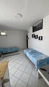 a room with a bed and a tv on the wall at case vacanza hoya in Lacco Ameno