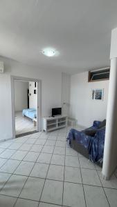 a living room with a couch and a bedroom at case vacanza hoya in Lacco Ameno