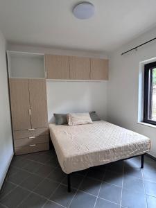 a bedroom with a bed and cabinets and a window at Villa del Limone in Sellia Marina