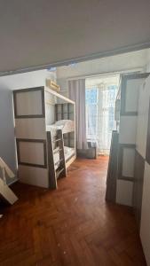 a room with a bedroom with a bed and a window at BakuDowntownHostel in Baku