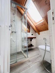 a bathroom with a glass shower and a toilet at JOEN Village in Librazhd +93 photos