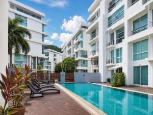 an image of an apartment building with a swimming pool at Dee Residence Phuket in Patong Beach