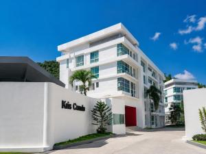 a white building with a nitz group sign on it at Dee Residence Phuket in Patong Beach