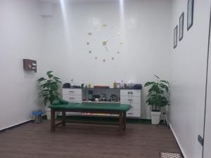 a room with a bench and a clock on the wall at S1 Modern & Relax in Agadir