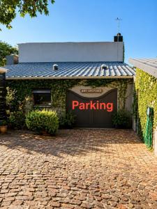 a parking garage with a parking sign on it at Art-Inspired Bedroom Close to CBD in Mossel Bay +11 photos